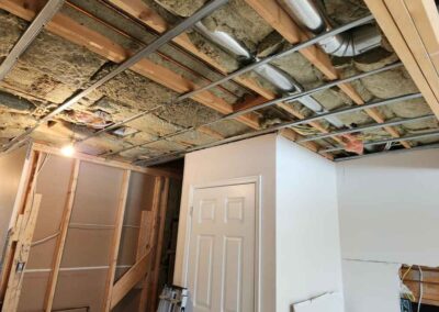 Exposed ceiling with insulation, pipes and resilient for installing drywall