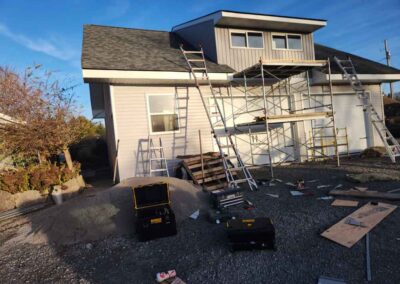 exterior of home with ladders and scaffolding set up against side