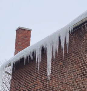 Ice dam forming on asphalt shingle roof in Trenton Ontario