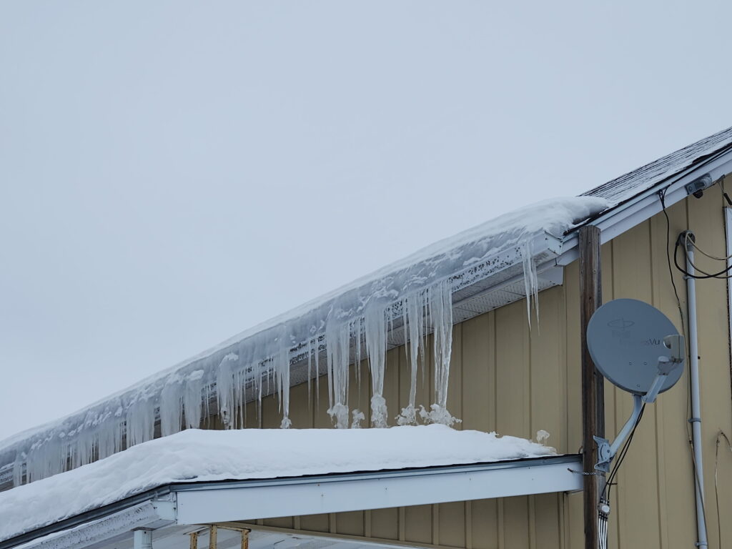 Ice dam buildup on residential roof in Trenton Ontario after heavy snowfall