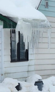 Ice buildup in roof valley area during winter storm