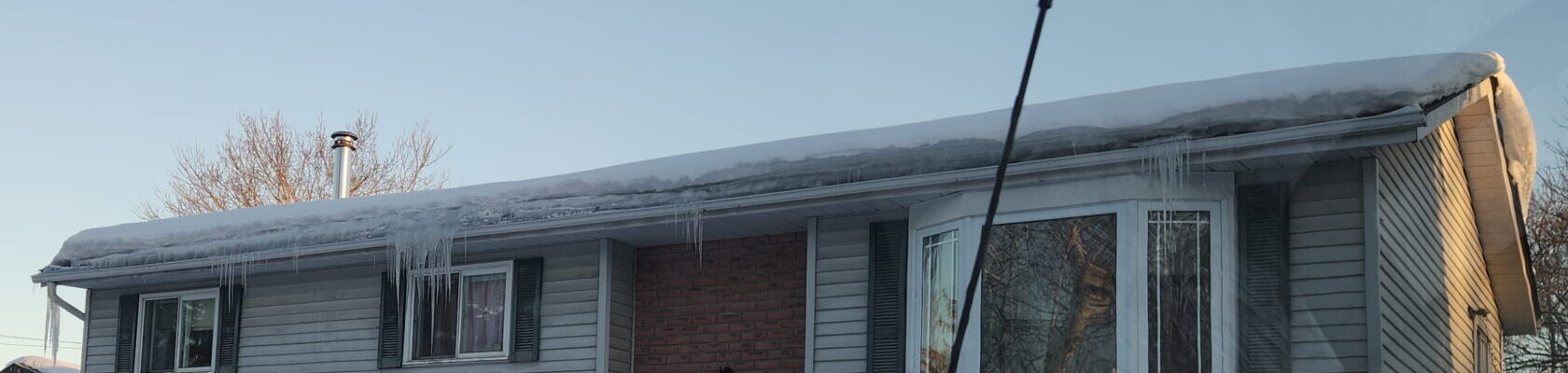 Ice dam forming along roof edge in Quinte West neighborhood