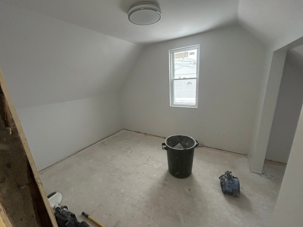Painting a bedroom during interior renovation in Belleville, Ontario