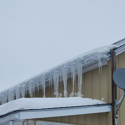 Ice dam buildup on residential roof in Trenton Ontario after heavy snowfall